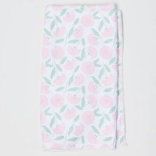 Floral patterned fabric with pink flowers and green leaves on a white background