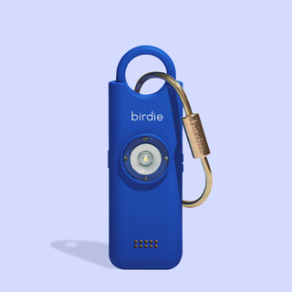 Blue device with a carabiner on a light purple background