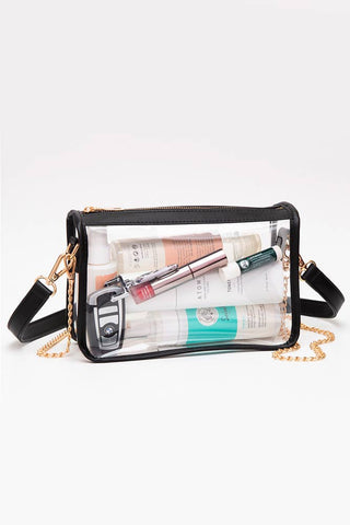 Clear handbag with cosmetic products on a white background