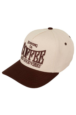 Beige and brown cap with text 'Running on Coffee and Good Vibes' on a white background