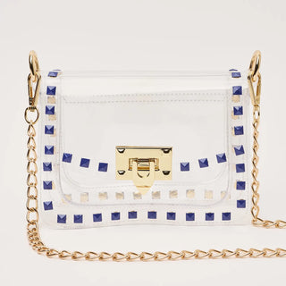 White handbag with blue studded details and a gold chain strap on a white background
