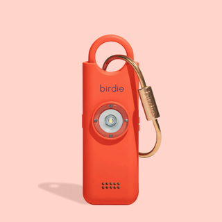 Orange device with a gold carabiner on a pink background, branded 'birdie'.