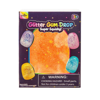 A box of Fun World Glitter GUM DROP Super Squishy! toy, featuring a dark purple background with a large orange glittery square in the center and four smaller glittery gem shapes in purple, pink, yellow, and blue around it.