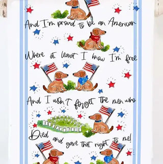 Tea towel with patriotic design featuring dogs, flags, and text on a white background.