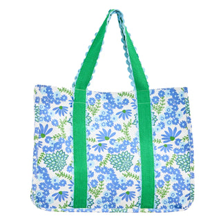 Floral tote bag with blue flowers and green straps on a white background