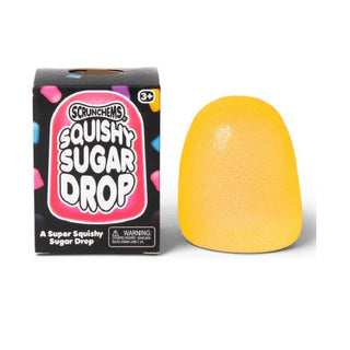 Yellow squishy toy next to its packaging on a white background