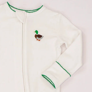 White baby onesie with green trim and a duck design on a light gray background