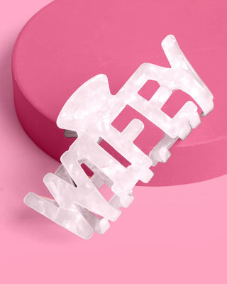 White hair clip on a pink background