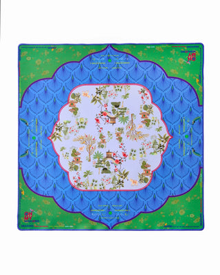 Decorative quilt with a blue border and colorful floral pattern on a green background