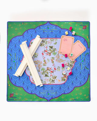 Colorful game board with pieces and cards on a white background