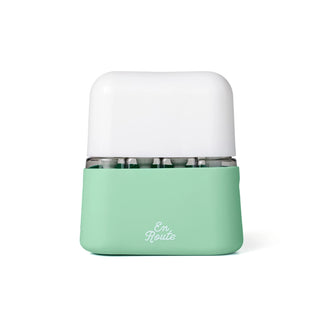 Mint green and white container with 'En Route' branding on a white background