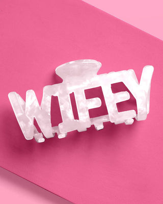 Clear hair clip with 'WIFEY' text on a pink background