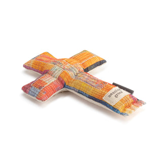 Colorful dog toy shaped like a cross on a white background