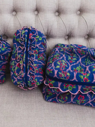 Blue floral-patterned bags on a gray textured surface