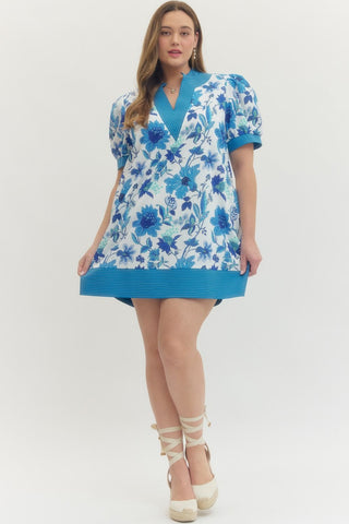 Woman wearing a blue floral dress on a white background