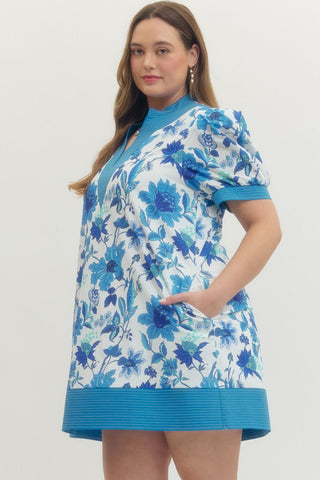 Woman wearing a blue floral dress on a white background