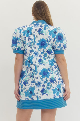 Woman wearing a blue floral dress on a white background