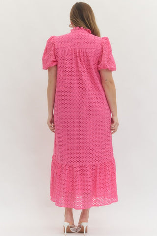 Woman wearing a pink dress with a white background