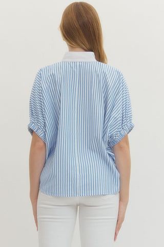 Woman wearing a blue and white striped shirt on a plain background