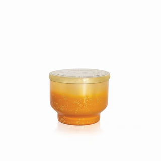 Orange glass container with a lid on a white background