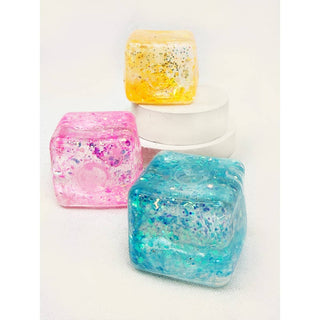 Three colorful resin cubes on a white background