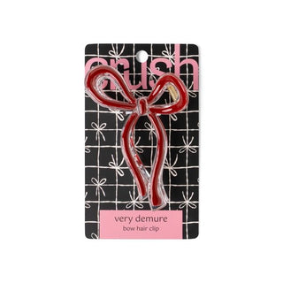 Red bow hair clip on a branded card with 'Brush' logo