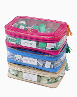 Stack of colorful travel bags with labels on a white background