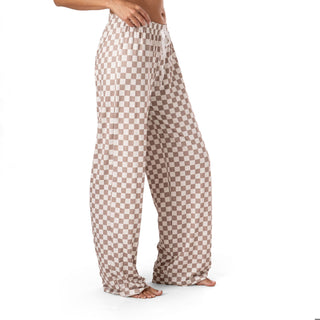 Checkered pajama pants worn by a person on a white background
