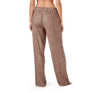 Leopard print pants worn by a person on a white background