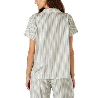 Woman wearing a striped pajama set on a white background