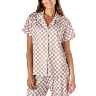 Woman wearing a brown and white checkered shirt and pants on a white background