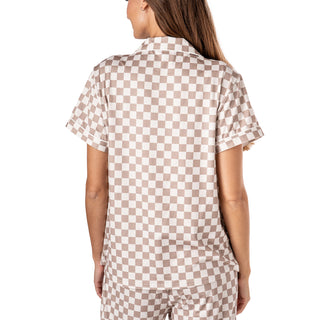 Person wearing a brown and white checkered outfit on a white background