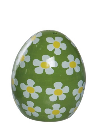 Green egg-shaped object with white daisy patterns on a white background