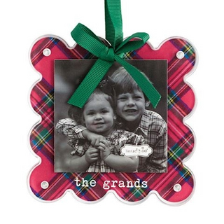 Plaid ornament with a photo of two children and a green ribbon on a white background