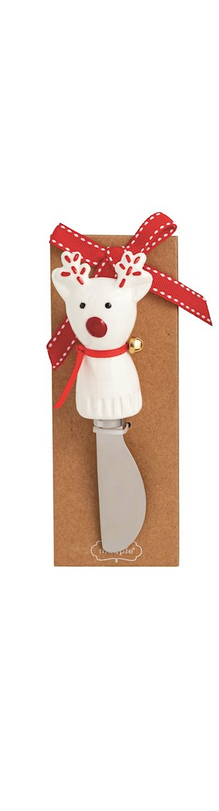 Polar bear-shaped knife with a red ribbon in a cardboard holder on a white background