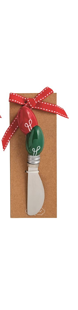 Decorative cheese knife with green and red handle in a box with a red ribbon on a white background