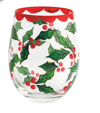 Decorative glass with holly design and red rim on a white background