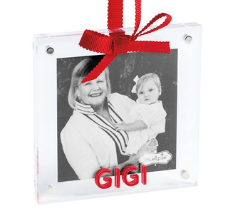 Decorative photo ornament with a red ribbon and black and white photo of a woman holding a child, with 'GIGI' text.
