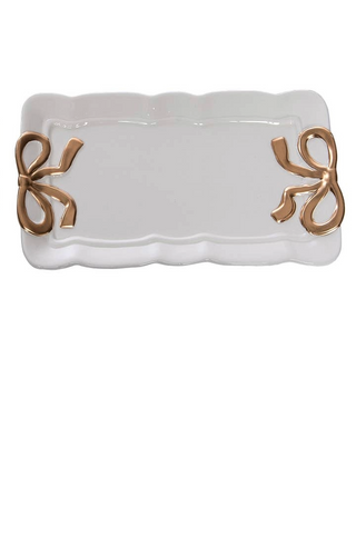 White ceramic dish with gold decorative elements on a white background