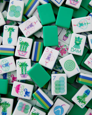 Collection of colorful Mahjong tiles with various designs on a green background