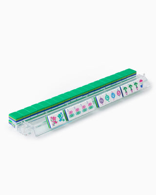 Transparent plastic stamp set with green top and colorful stamps on a white background