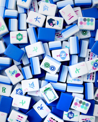 Assorted colorful Mahjong tiles on a blue background