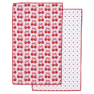 Two patterned cloths with cherry and heart designs on a white background