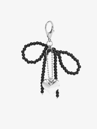 Black beaded charm with a heart-shaped pendant on a white background