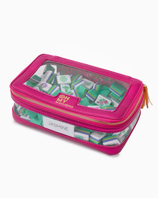 Pink pencil case with transparent lid displaying stationery items on a white background