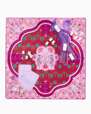 Board game with colorful design on a pink and red patterned board