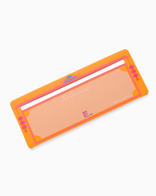 Rectangular makeup product with orange border and pink accents on a white background