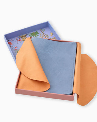 Two fabric samples, one orange and one blue, in an open box with a decorative lid.