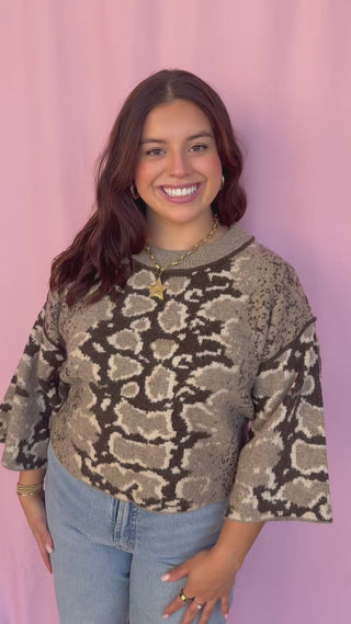 woman wearing a printed sweater 